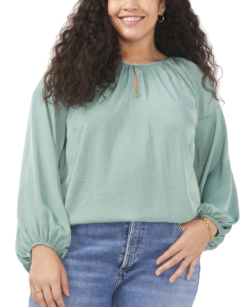 Front of a model wearing a size 1X Aria Peasant Blouse in TEAL LAKE by Vince Camuto. | dia_product_style_image_id:261007